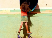 Girl standing on bike